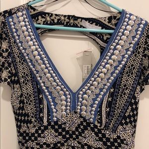 Printed dress with hand stitched embellishments.